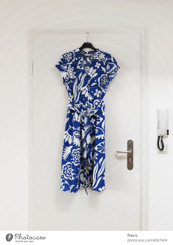 A summer dress hangs on the door Fashion Hanger door handle Dress variegated Intercom system Pattern Blue Clothing