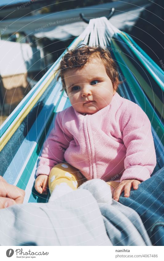 Little baby having fun on a hammock in a sunny day happy holidays lifestyle family babyhood child kid girl cute lovely time enjoy happiness leisure freedom