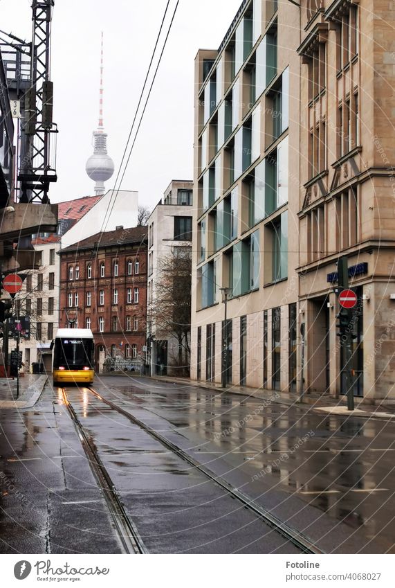 Berlin from its grey side. Even the TV tower hides in the grey in grey. Only the tram shines bright yellow. Tram Exterior shot Colour photo Capital city Town