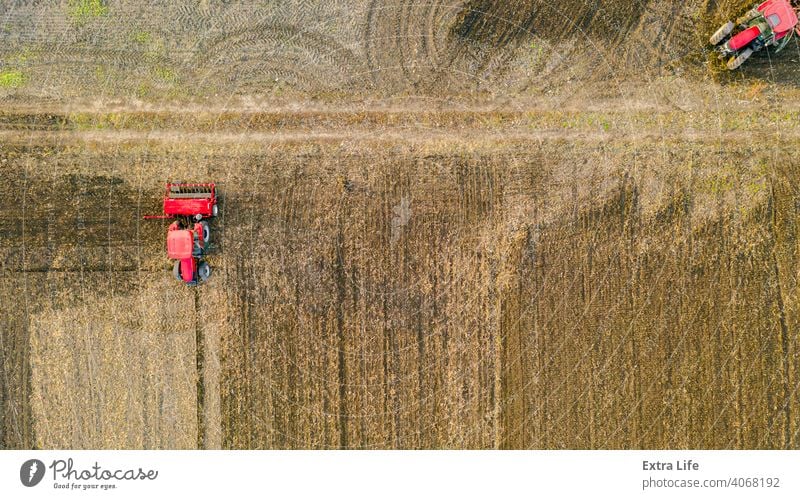 Above top view shot of three tractors, they are pulling machines, over arable field, preparing soil for new crop Aerial Agricultural Agriculture Agriculturist