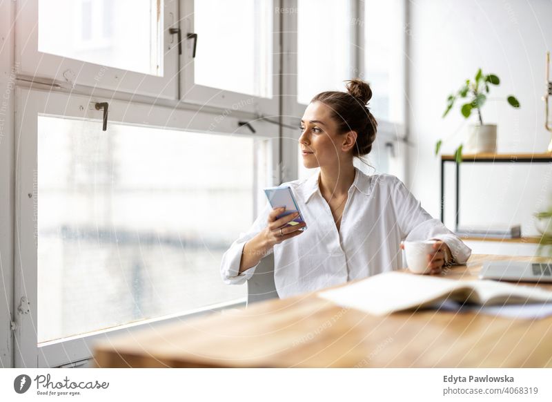 Creative business woman using smartphone in loft office millennials student hipster indoors window natural girl adult attractive successful people confident