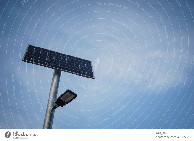 Solar powered street lighting in front of neutral blue sky with veil clouds| Climate - compliant streetlamp Solar system solar powered Sky Lamp Street lighting