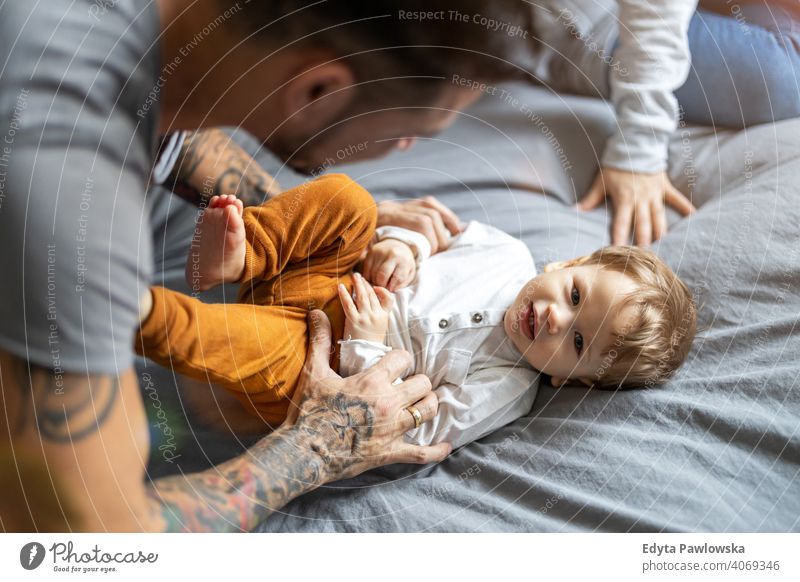 https://www.photocase.com/photos/4069346-father-tickling-his-little-son-in-bed-photocase-stock-photo-large.jpeg