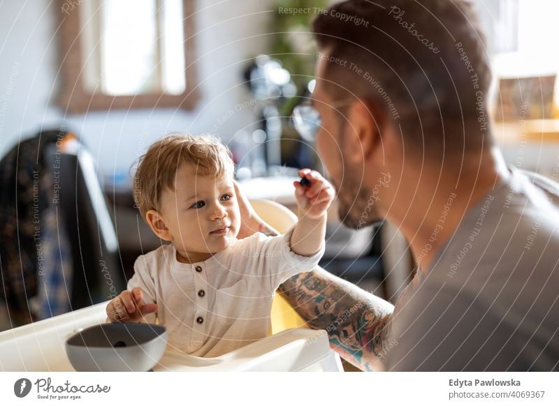 https://www.photocase.com/photos/4069367-single-dad-feeding-his-baby-who-is-sat-in-a-high-chair-photocase-stock-photo-large.jpeg