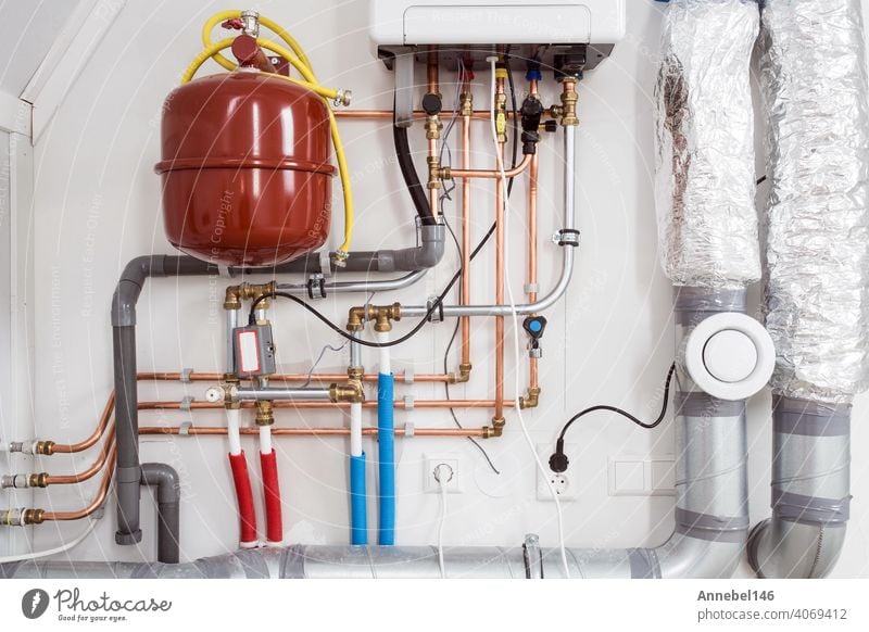 Heating installation and central boiler heating system on wall in house close-up water plumbing plumber repair service home man worker fix installing