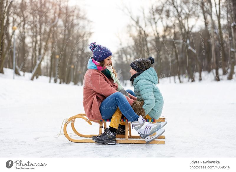 Mother and son having a great winter day outdoors playing in the snow mother daughter season together frozen cheerful fun kid people park holiday forest