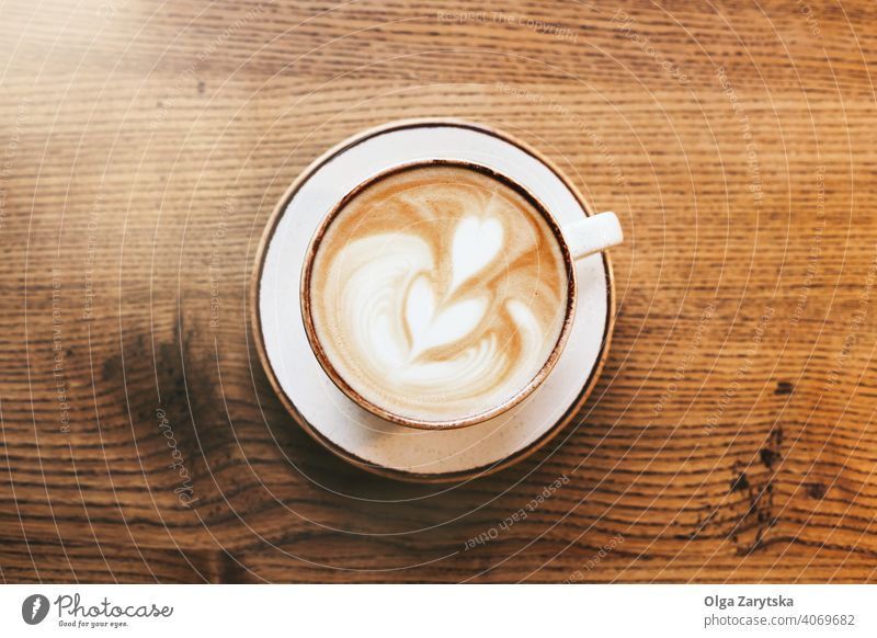 A cup of cappuccino on wooden table. coffee art latte cafe background heart couple mug milk white beverage brown drink espresso foam hot caffeine italian aroma