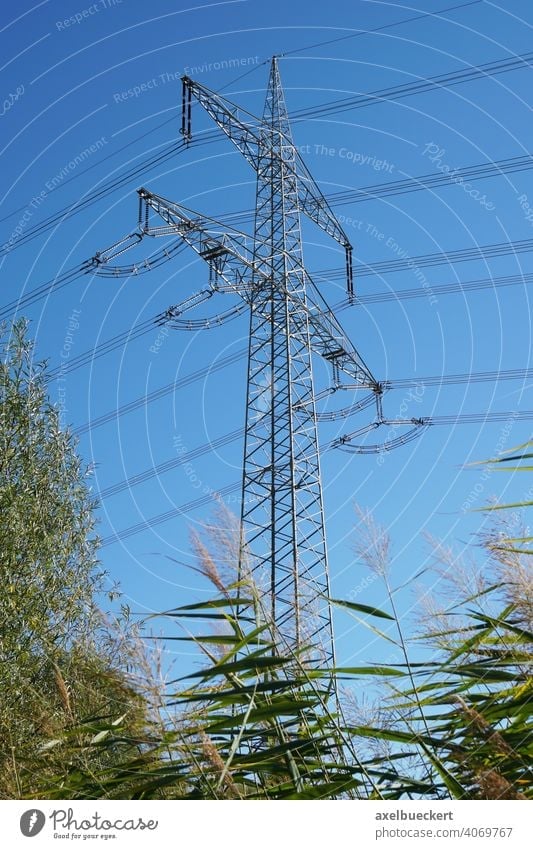 high-voltage transmission tower or pole or electricity pylon power line energy overhead utility cable high-tension conductor nature sky industry technology