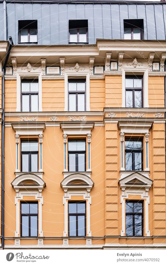 Orange brick art nouveau building façade with nine cream windows in Riga, Latvia, Europe art-nouveau baltic architecture facade latvia riga house old city