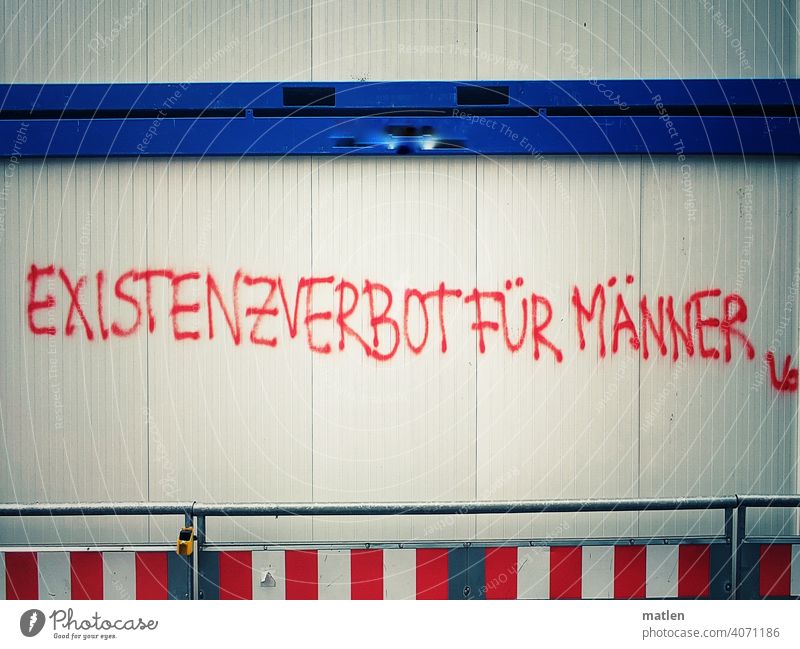 Existence ban Construction site Graffiti men writing Deserted Exterior shot Colour photo Text motto Genderism Alarming Unculture