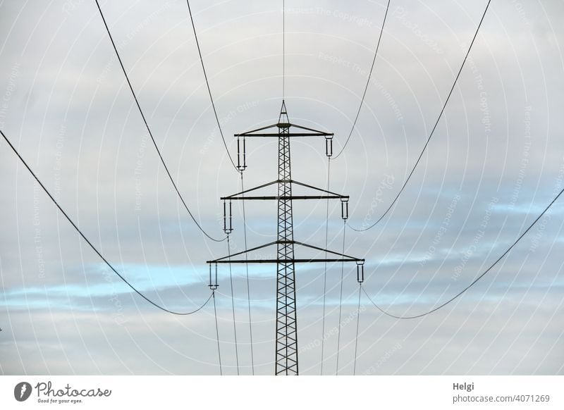 Power pole with high voltage lines in front of cloudy sky II Electricity pylon Power lines Energy High voltage power line Energy industry Technology