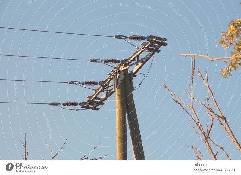 Wooden power pole with four power lines in front of blue sky Electricity pylon stream energy supply co2 Power lines Energy Management Technology Metal