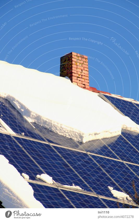 Photovoltaic system on the roof of a residential building partially covered with snow Solar Energy roof area Apartment Building photovoltaic system power supply