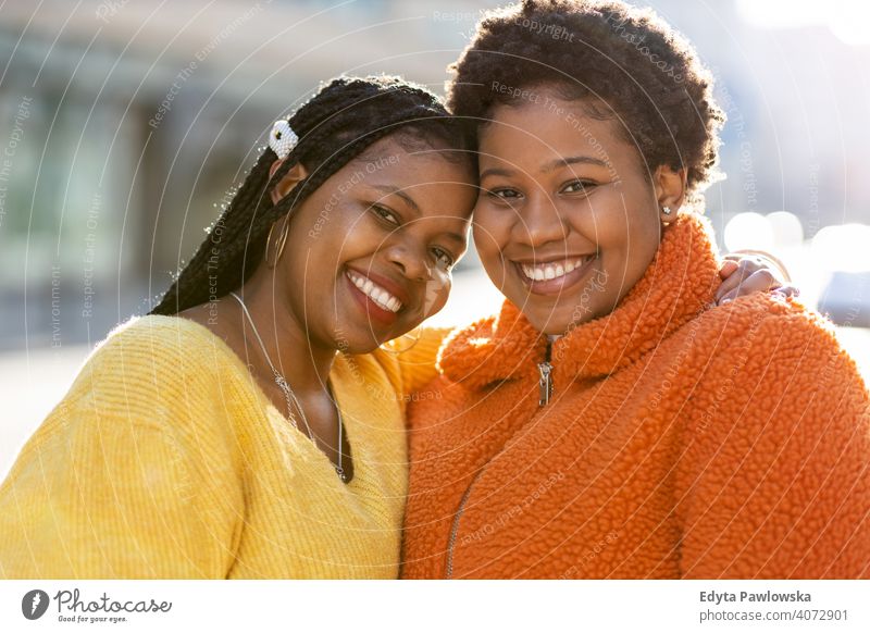 Portrait of two beautiful women standing together outdoors diversity diverse people love day positivity confident carefree woman young adult casual attractive