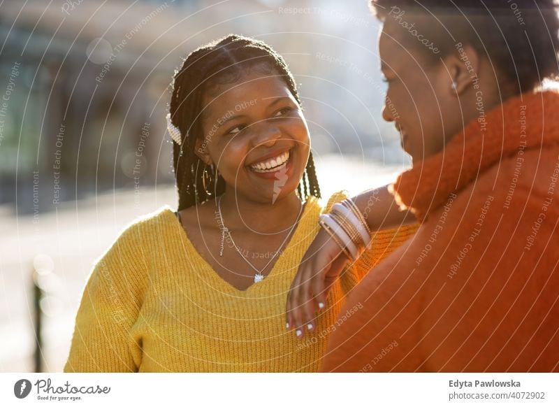 Portrait of two beautiful women standing together outdoors diversity diverse people love day positivity confident carefree woman young adult casual attractive