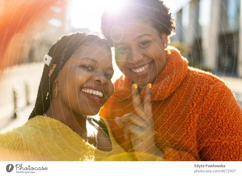 Beautiful happy girlfriends taking a selfie together diversity diverse people love outdoors day positivity confident carefree woman young adult casual beautiful