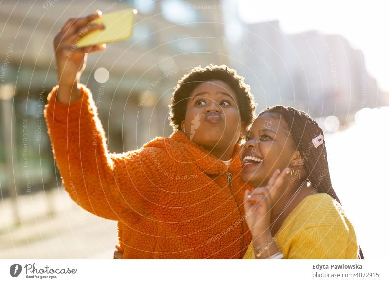 Beautiful happy girlfriends taking a selfie together diversity diverse people love outdoors day positivity confident carefree woman young adult casual beautiful