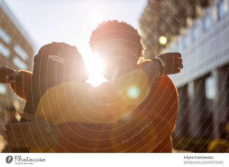 Portrait of two beautiful happy girlfriends embracing outdoors diversity diverse people love day positivity confident carefree woman young adult casual