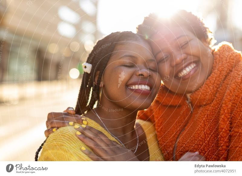 Portrait of two beautiful happy girlfriends embracing outdoors diversity diverse people love day positivity confident carefree woman young adult casual