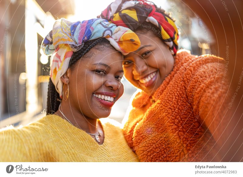 Beautiful happy girlfriends taking a selfie together diversity diverse people love outdoors day positivity confident carefree woman young adult casual beautiful