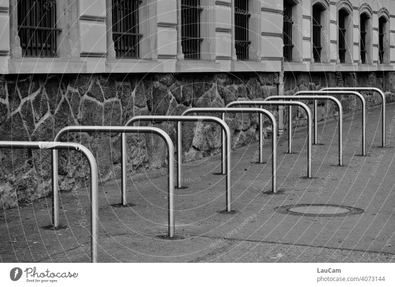 Empty metal bike racks outside a school in the Corona pandemic Bicycle Cycling Bicycle rack Wheel Symmetry symmetric wheel stand Abstract Mobility Vacancy