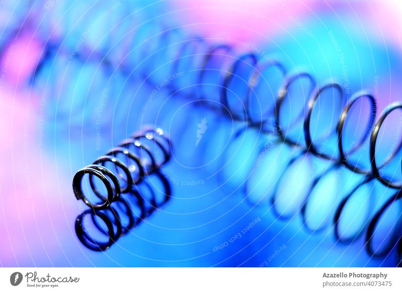 Iron spirals in blur. Shiny metal springs in blur. abstract art blue blurry closeup coiled color composition concentrate create creativity defocused design dna