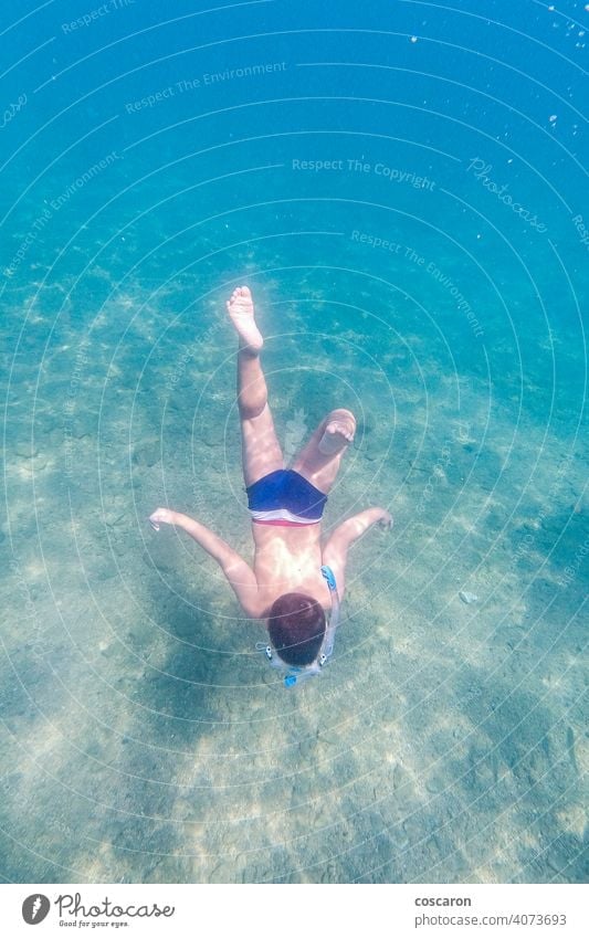 Little kid snorkeling on a clear water active active boy aqua beach beach vacation child childhood clear ocean coral reef deep down dive diving enjoy nature