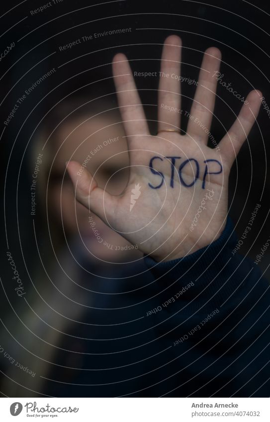 Stop! Woman holds your hand, which says Stop, against a window. stop Hold Border Hand Palm of the hand Human being Cancelation set boundaries say no Quit