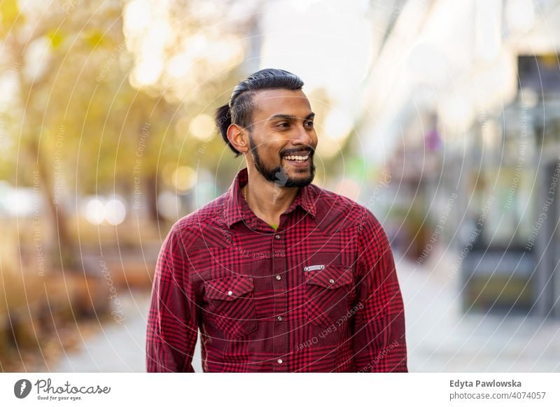 Portrait of a handsome young man on the city street Sinhalese asian Indian bearded outside urban standing outdoors Warsaw one casual lifestyle guy attractive