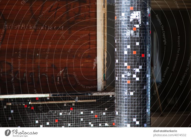 Tiled column in front of closed roller shutters Architecture Dark tiles House (Residential Structure) Mosaic Gray Red Black White Pattern Exterior shot Deserted