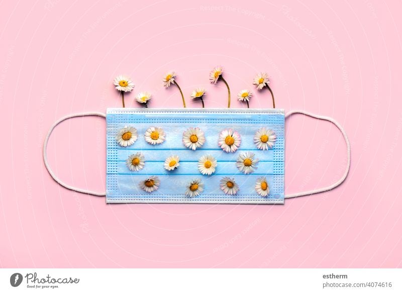 Protective surgical mask with white daisy flowers.Concept of an spring allergy coronavirus protective surgical mask medical face masks medical mask 2019-ncov