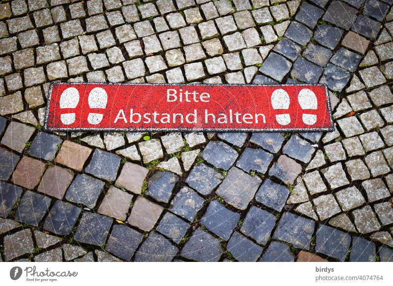 Please keep your distance. Marking on cobblestones of a weekly market keep sb./sth. apart gap Hygiene rules corona Protection Risk of infection prevention