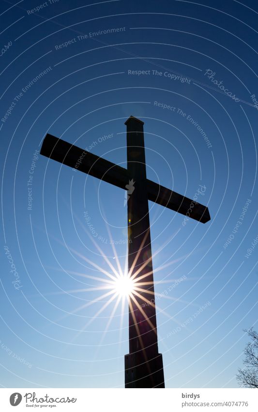 Christian field cross in front of blue sky with shining sun. Cross, backlight shot Crucifix Christianity Church Christian cross Religion and faith Catholicism