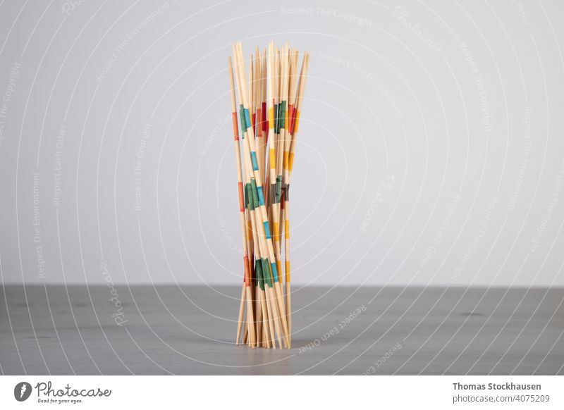 mikado game sticks, fallen down on a wooden board, motion blur balance challenge chaos children game colorful concentration copy space desk fun games group