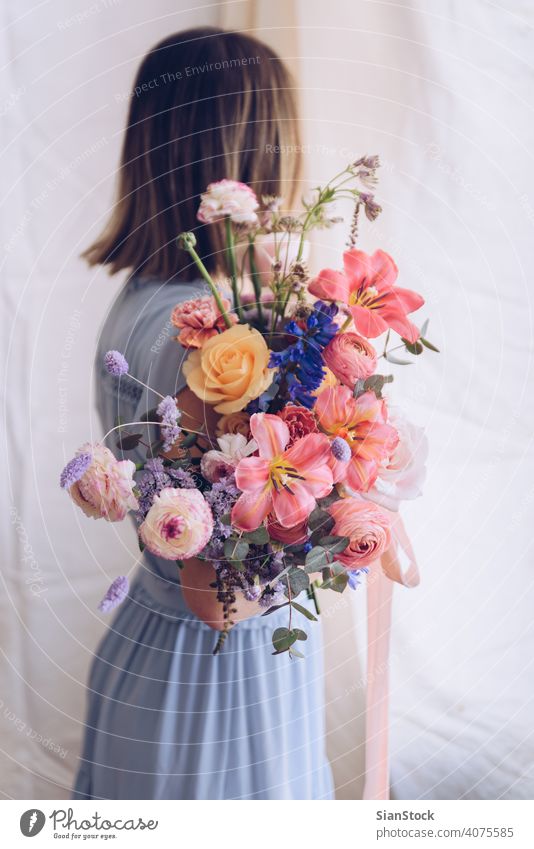 Young woman in a light blue dress holding a bouquet of flowers. Romantic concept. girl soft light beautiful vintage wedding white young beauty happy pink cute