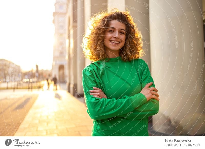 Portrait of young woman with curly hair in the city natural sunlight urban hipster stylish positive sunny cool afro joy healthy freedom sunset enjoyment summer