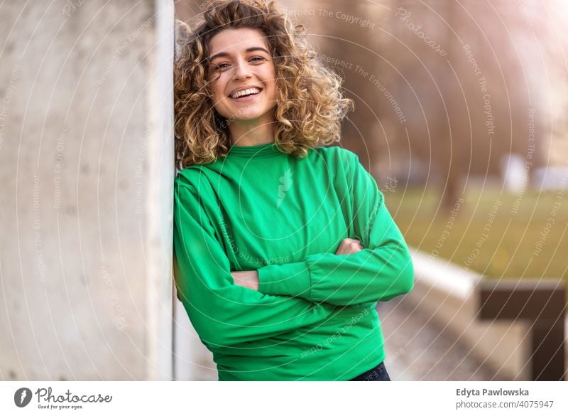 Portrait of young woman with curly hair in the city natural sunlight urban hipster stylish positive sunny cool afro joy healthy freedom sunset enjoyment summer