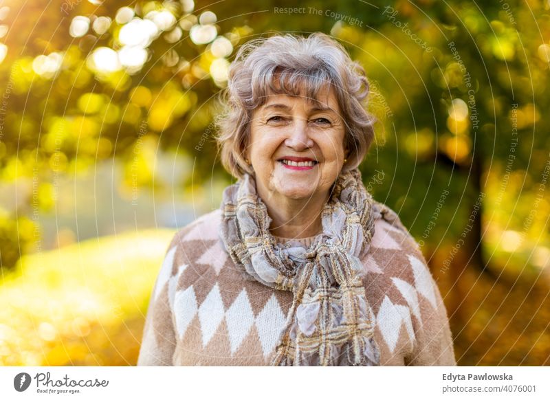 Portrait of a happy senior woman outdoors in autumn real people retired pensioner retirement aged grandmother grandparent day portrait caucasian old female