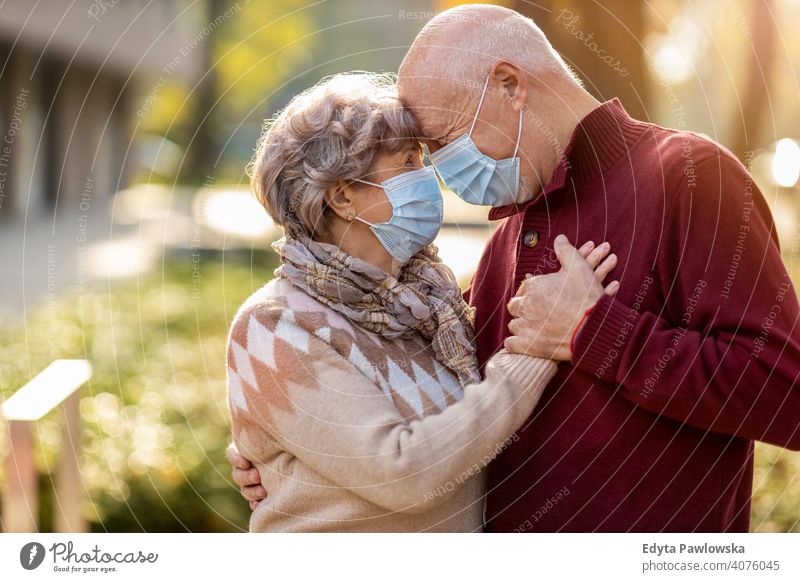 Senior couple wearing protective face masks outdoors senior love real people retired pensioner retirement aged grandmother grandparent grandfather day two