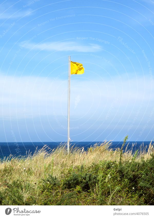 Attention, yellow flag on the beach attention background beautiful blue caution clean cloud color danger dangerous grass hazard high holiday leisure lifeguard
