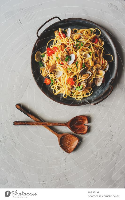 Pasta Spaghetti alle Vongole Seafood pasta with Clams in frying cooking pan with cherry tomatoes and garlic sauce seafood clam shell raw fresh shellfish vongole