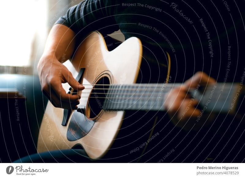 Young man playing acoustic guitar - a Royalty Free Stock Photo from  Photocase