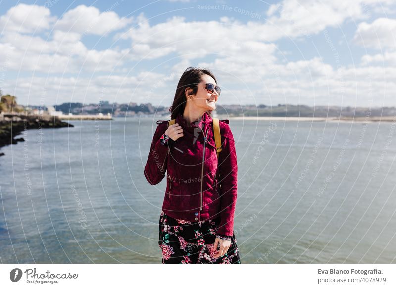 young caucasian backpacker woman sightseeing Porto views by the river. Travel and friendship concept sun travel spring city urban beautiful people tour tourism