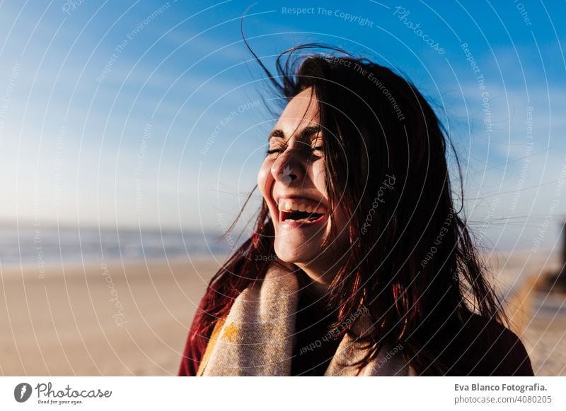 happy woman having fun at the beach on a windy day at sunset. Holidays and fun concept laughing happiness relax caucasian vacation holidays runway passage