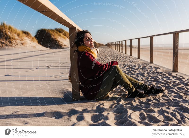 young caucasian woman with eyes closed relaxing at the beach at sunset. Holidays and relaxation concept vacation holidays runway passage attractive pretty