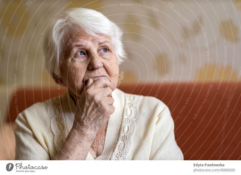 Senior woman lost in thought people senior mature casual female Caucasian elderly home house old aging domestic life grandmother pensioner grandparent retired