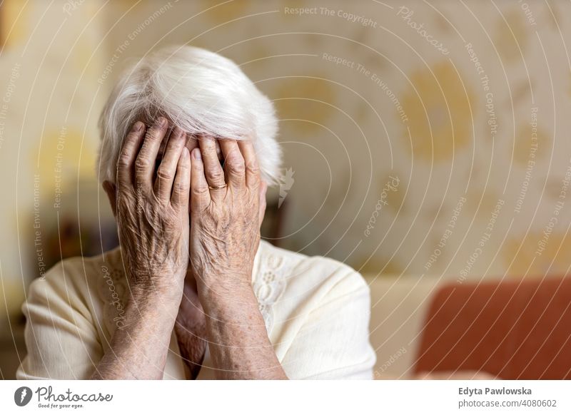 Senior woman covering face with her hands sad lonely unhappy depression uncertainty anxiety worried fear grief mental health distraught sadness loss problem