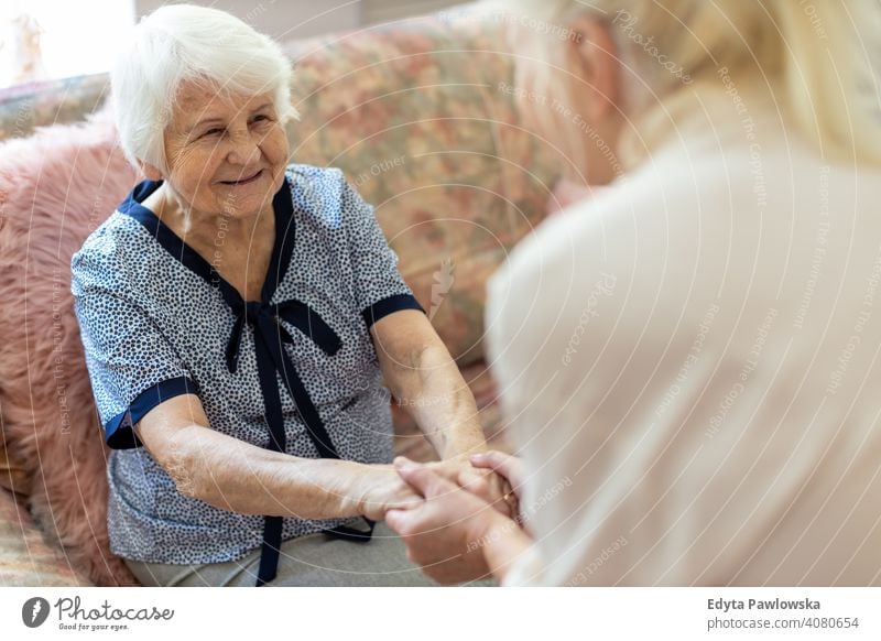 Senior woman spending quality time with her daughter smiling happy enjoying positivity vitality confidence people senior mature casual female Caucasian elderly