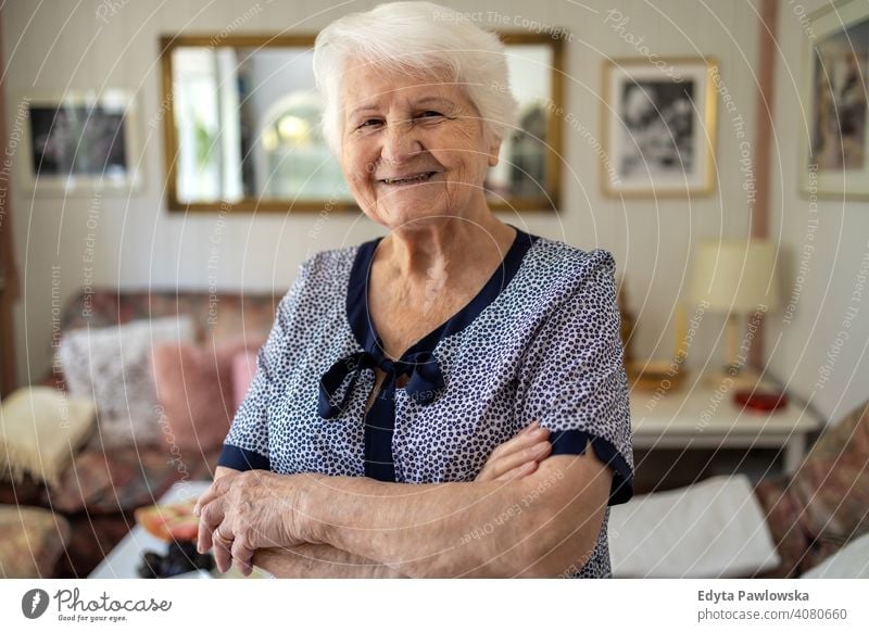 Portrait of an elderly woman at home smiling happy enjoying positivity vitality confidence people senior mature casual female Caucasian house old aging
