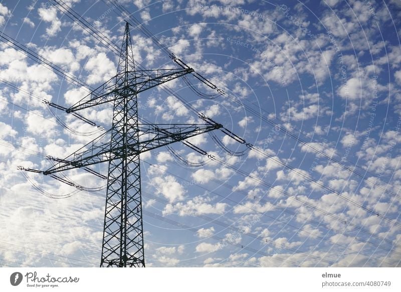 Overhead Power Pole with High Voltage Lines against a Blue Sky with Sheep Clouds / Power Pole / Energy Electricity pylon Overhead line mast power line